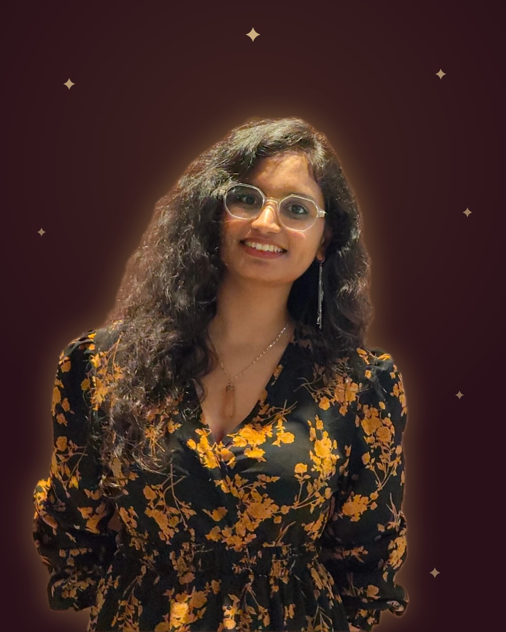 Aagyaa Pathak, photographed against a deep wine backdrop with gold sparkles